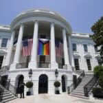 American flags and a pride flag hang from the White House during a Pride Month celebration on the South Lawn, Saturday, June 10, 2023, in Washington. AP Photo/Manuel Balce Ceneta